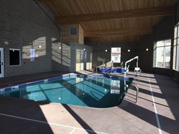 a large indoor swimming pool with a wooden ceiling at Augusta Apartments, Fargo, 58104